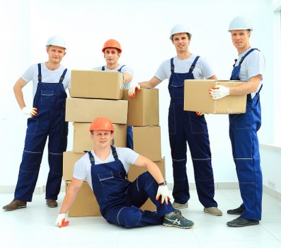 Business relocation scene showing office equipment and labelled boxes