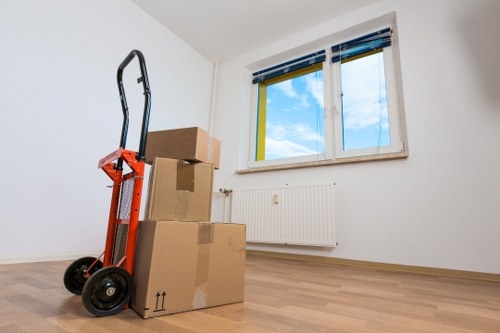 Local movers handling furniture in a Herne Hill street