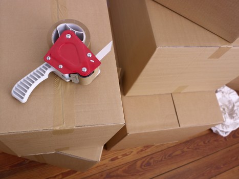 Careful wrapping of fragile household items during a packing service