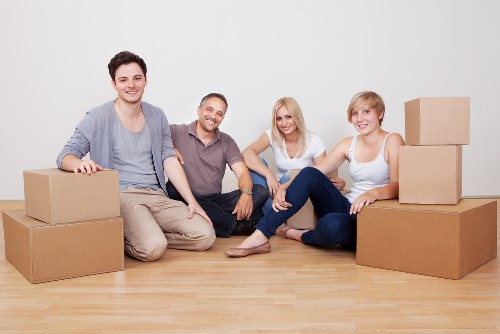 Movers carrying items through a Herne Hill property entrance